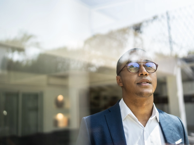 man looking out of window